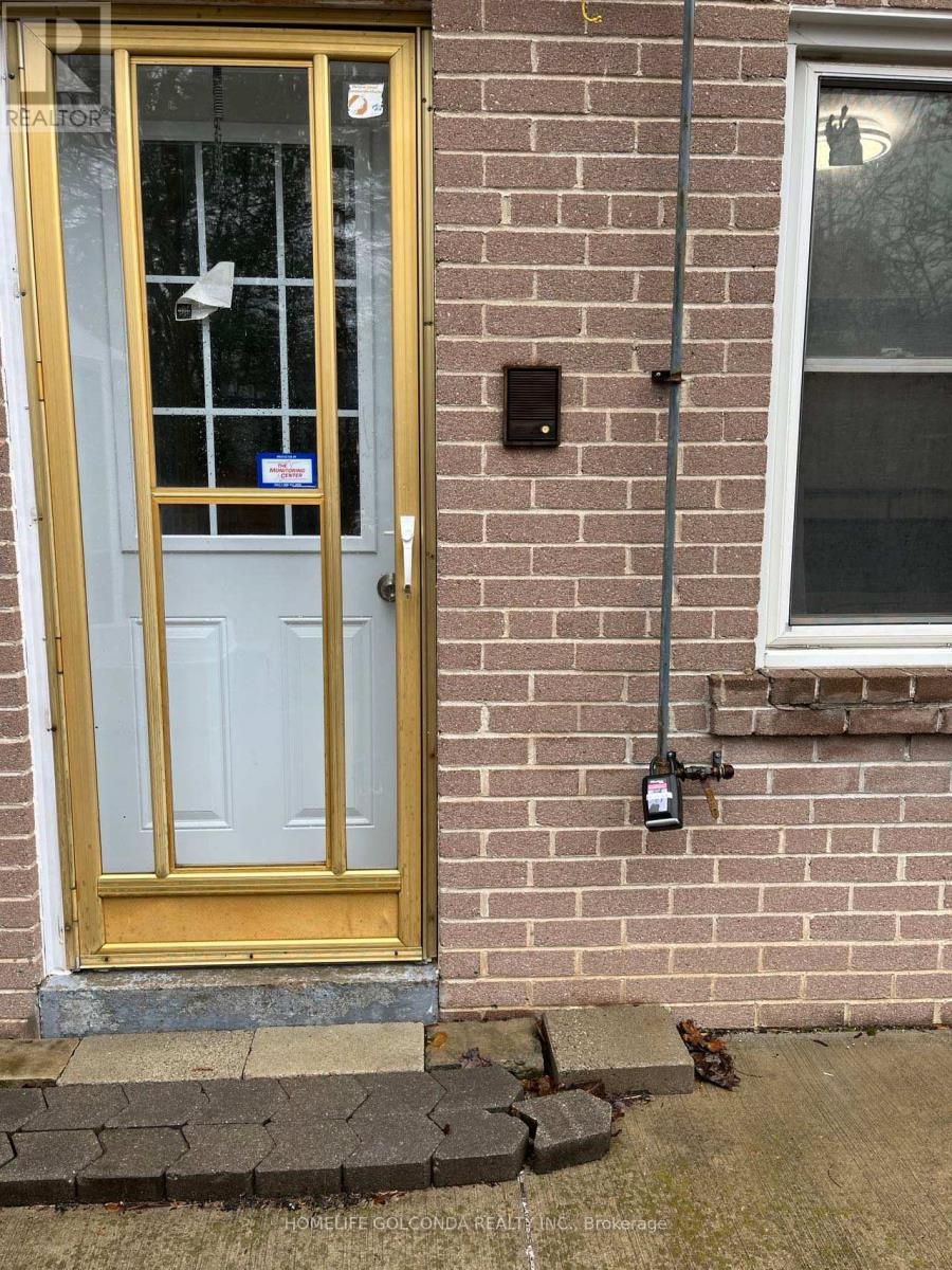 A yellow door with a glass window and a sign on it.