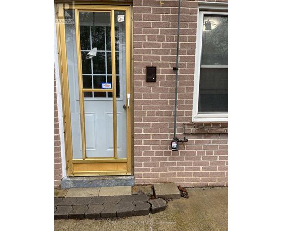A yellow door with a glass window and a sign on it.