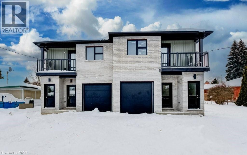 A two-story house with a balcony and a garage door.