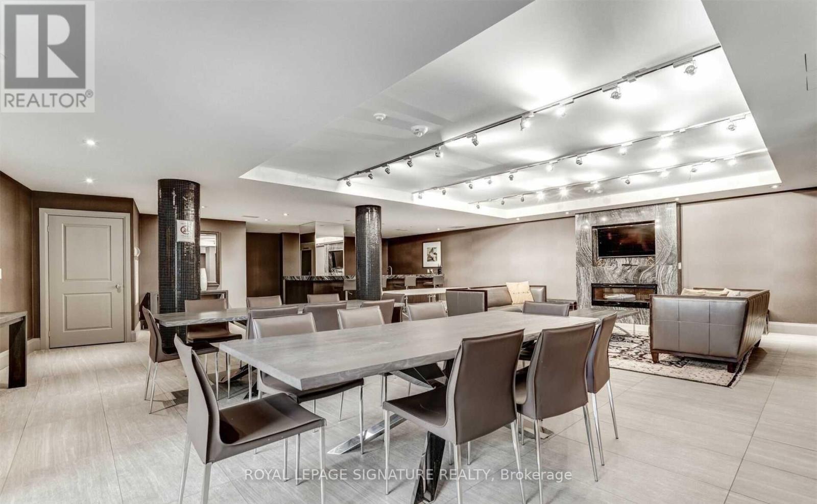 A modern dining room with a large table and chairs.