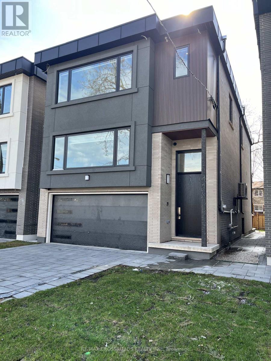 A modern two-story house with a garage is for sale.
