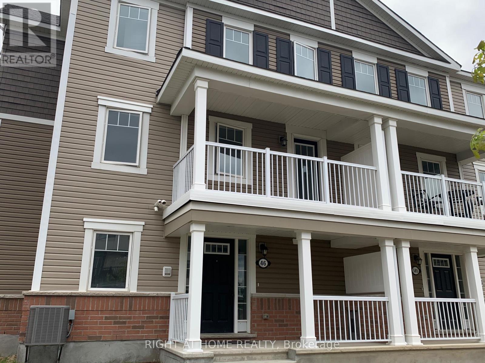 A two-story house with a balcony on the second floor.