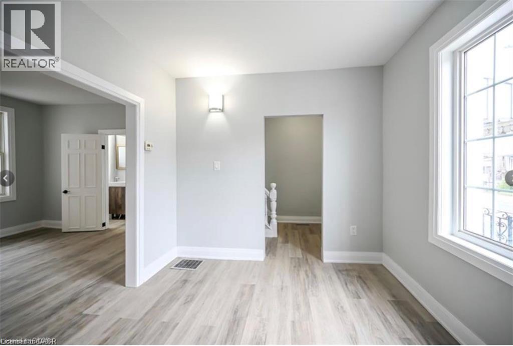 A room with a wooden floor and white walls.