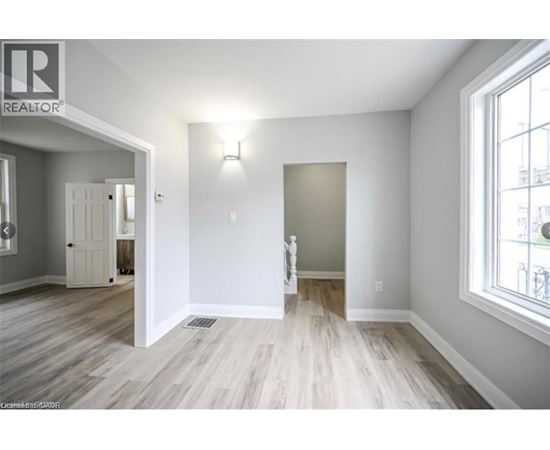 A room with a wooden floor and white walls.
