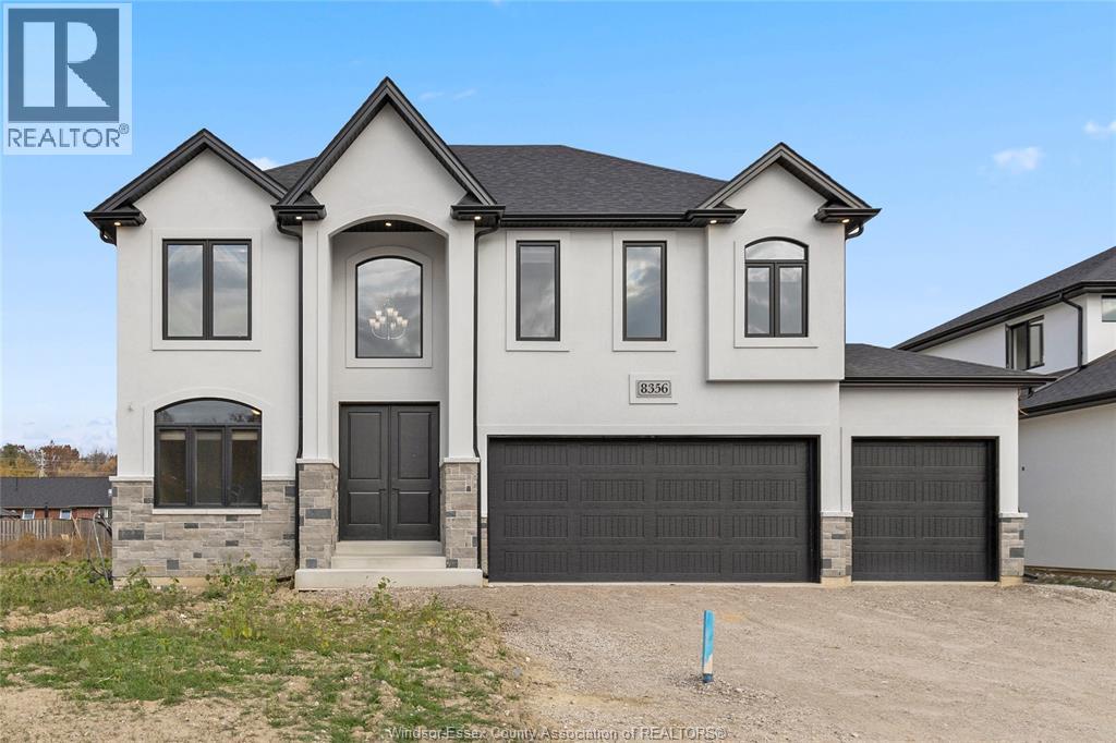A two-story house with a garage is for sale.