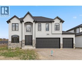 A two-story house with a garage is for sale.