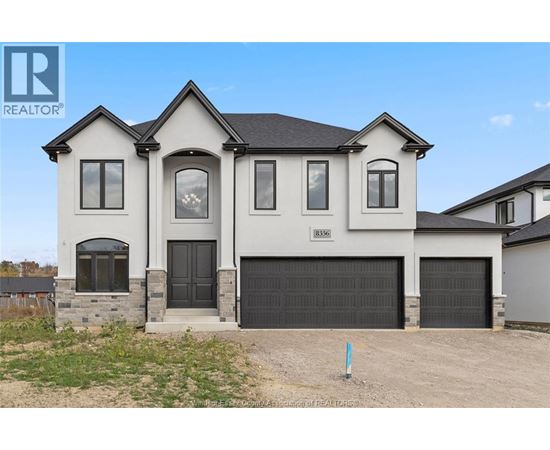 A two-story house with a garage is for sale.