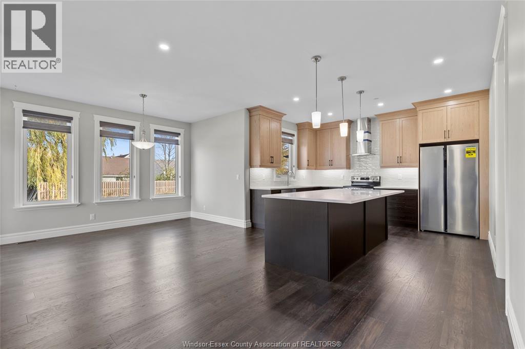 A modern kitchen with wooden cabinets and a central island.