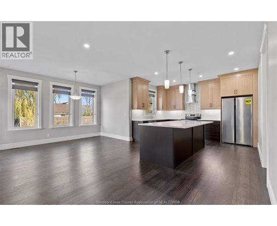 A modern kitchen with wooden cabinets and a central island.