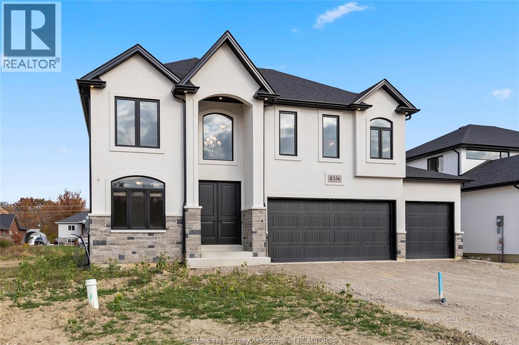 A large, two-story house with a garage is for sale.