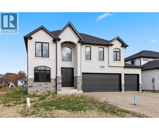 A large, two-story house with a garage is for sale.