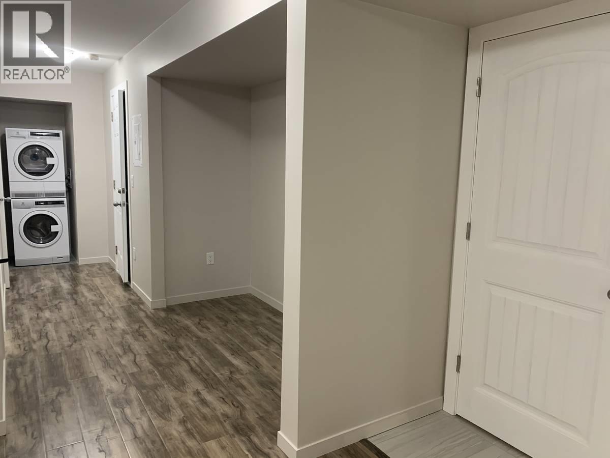 A laundry room with a washer and dryer stacked on top of each other.