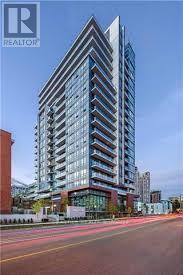 A tall, modern building with a glass facade is the focal point of the image.