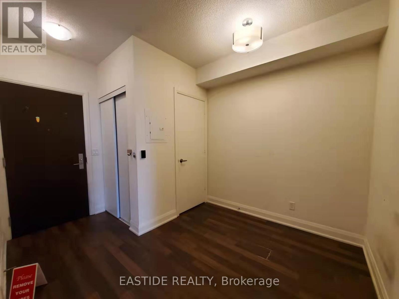 A room with a door and a sign that says "Eastside Realty, Brokerage".