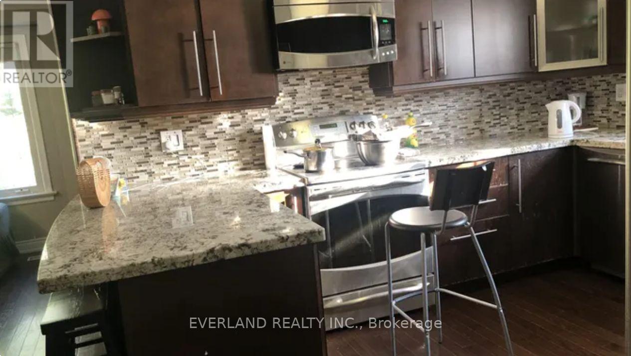 A kitchen with granite countertops and stainless steel appliances.