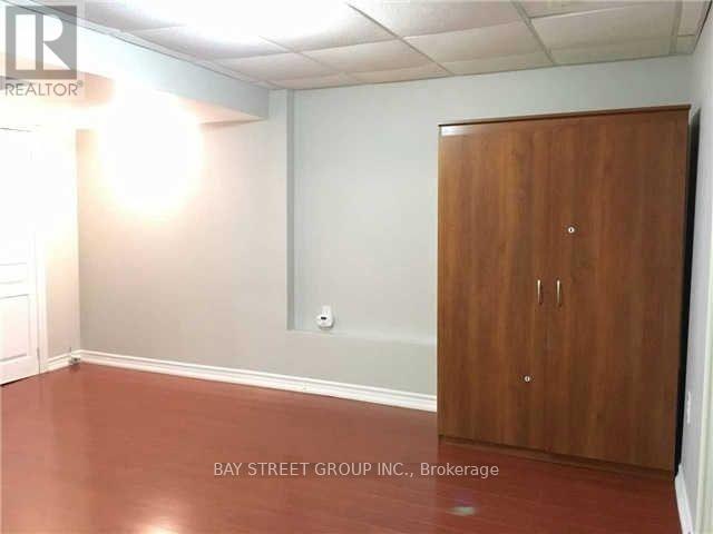 A room with a wooden door and a white wall.