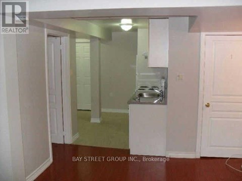A small kitchen with a sink and a refrigerator.