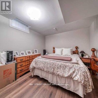 A bedroom with a bed, nightstand, and dresser.