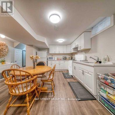 A well-lit kitchen with a dining table and chairs.
