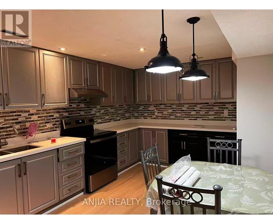A kitchen with a table and chairs in the foreground and a backsplash of tiles.