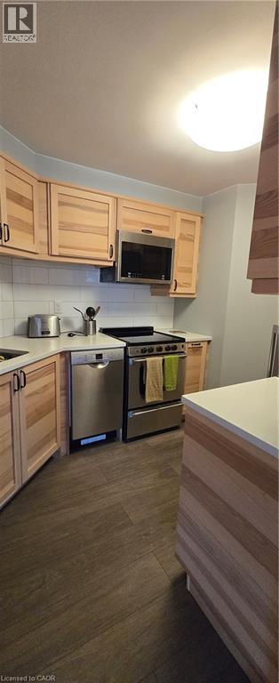 A kitchen with wooden cabinets and a stainless steel dishwasher.