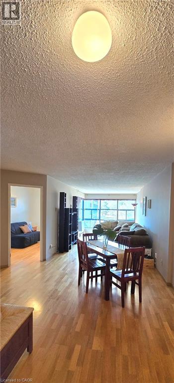 A dining room with a wooden table and chairs.
