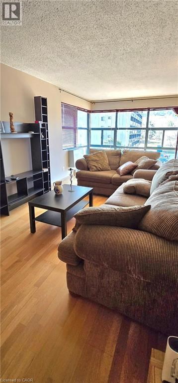 A living room with a brown couch and a black coffee table.
