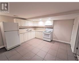 A kitchen with white appliances and cabinets.