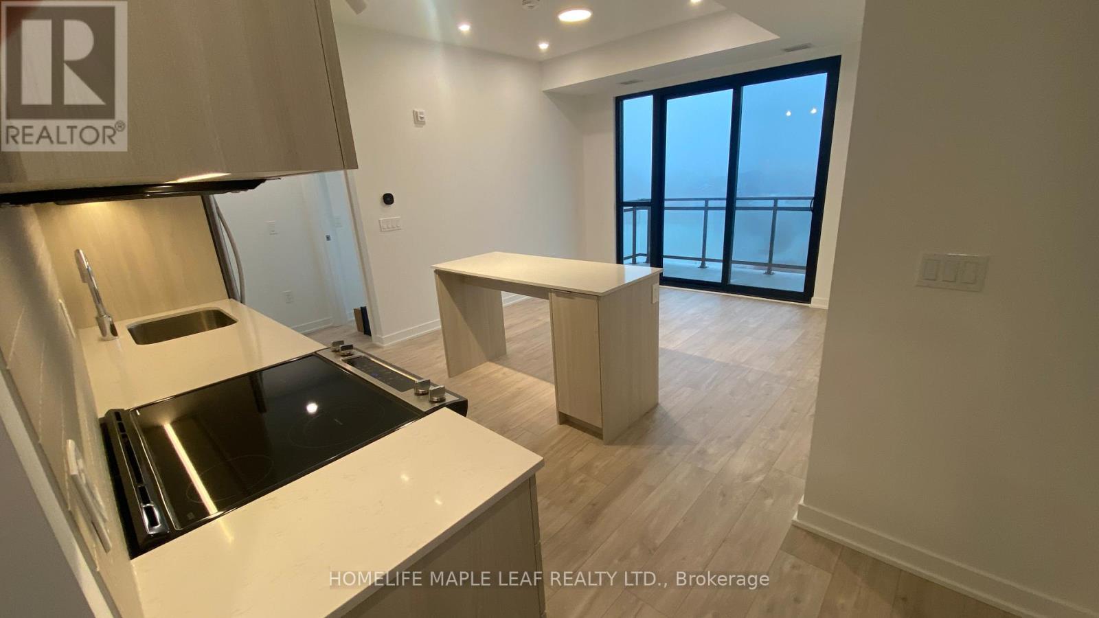 A kitchen area with a sink and a window.