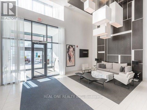 A modern living room with a grey rug and a white sofa.