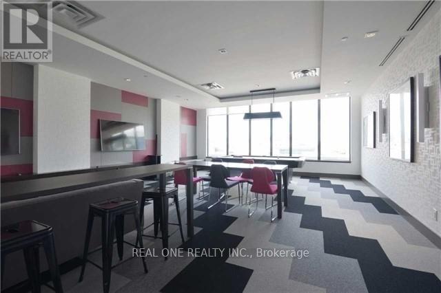 A modern dining area with a bar and chairs.