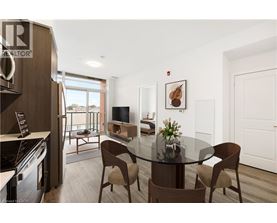 A modern dining room with a glass table and chairs.
