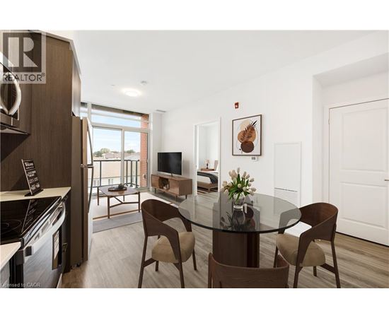A modern dining room with a glass table and chairs.