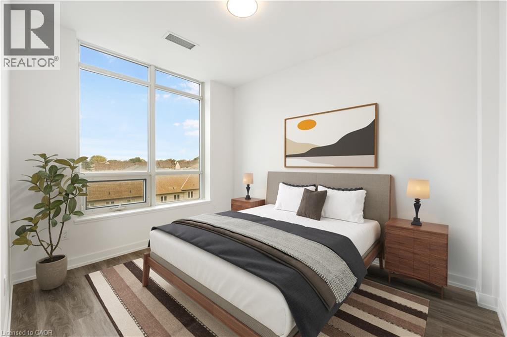 A bedroom with a large bed, a potted plant, and a painting on the wall.