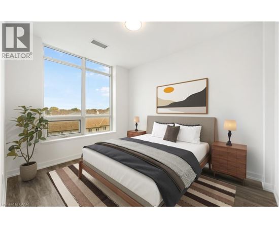 A bedroom with a large bed, a potted plant, and a painting on the wall.