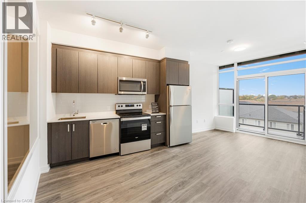 A modern kitchen with wooden cabinets and stainless steel appliances.