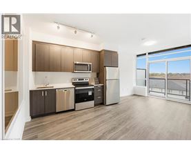 A modern kitchen with wooden cabinets and stainless steel appliances.