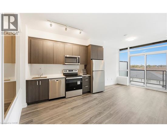 A modern kitchen with wooden cabinets and stainless steel appliances.