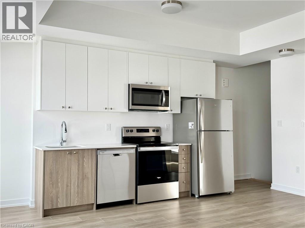 A kitchen with white cabinets and stainless steel appliances.