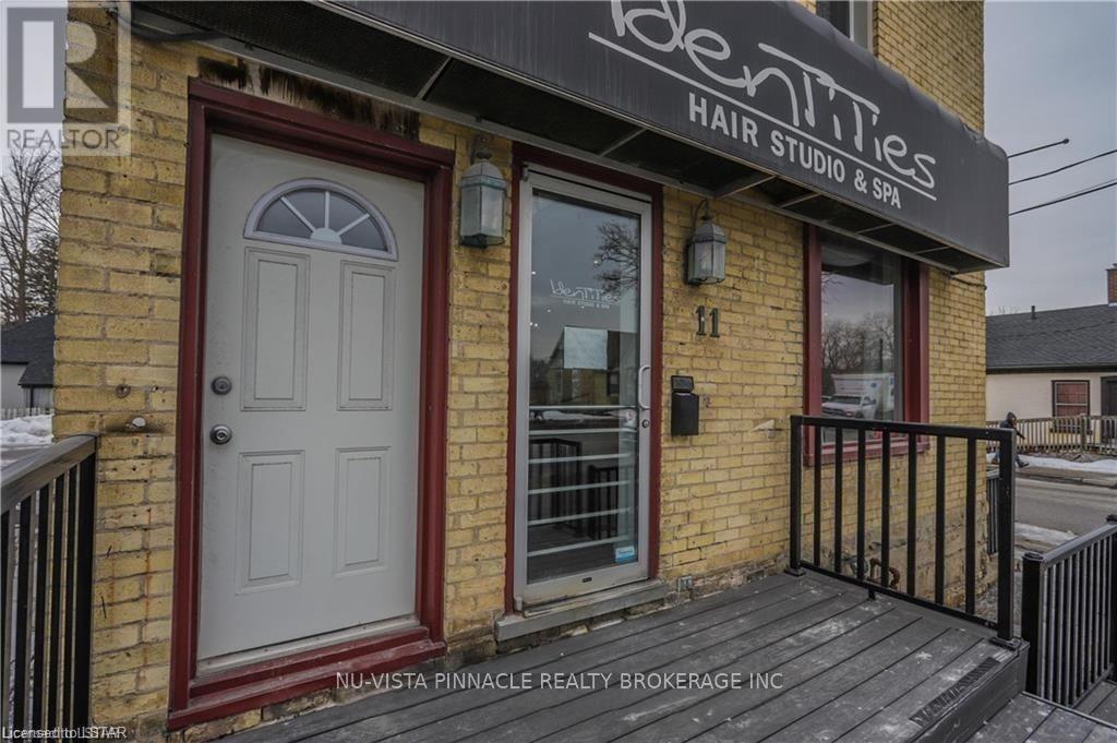 A brick building with a sign that says "Identities Hair Studio & Spa".