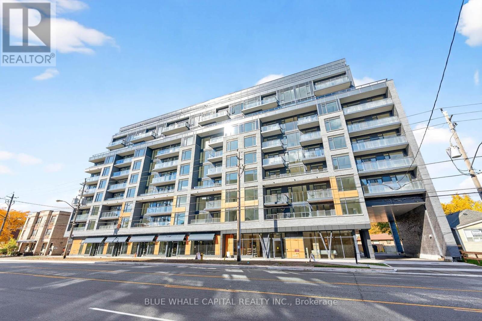 A large, modern apartment building with many windows and balconies.