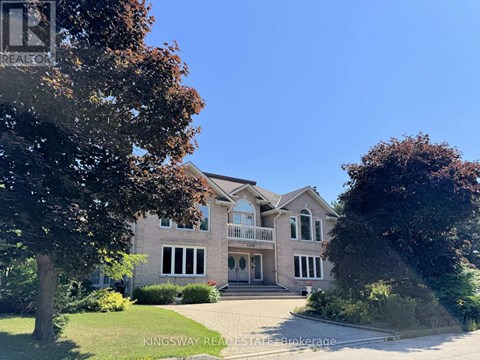 A large house with a driveway in front of it.