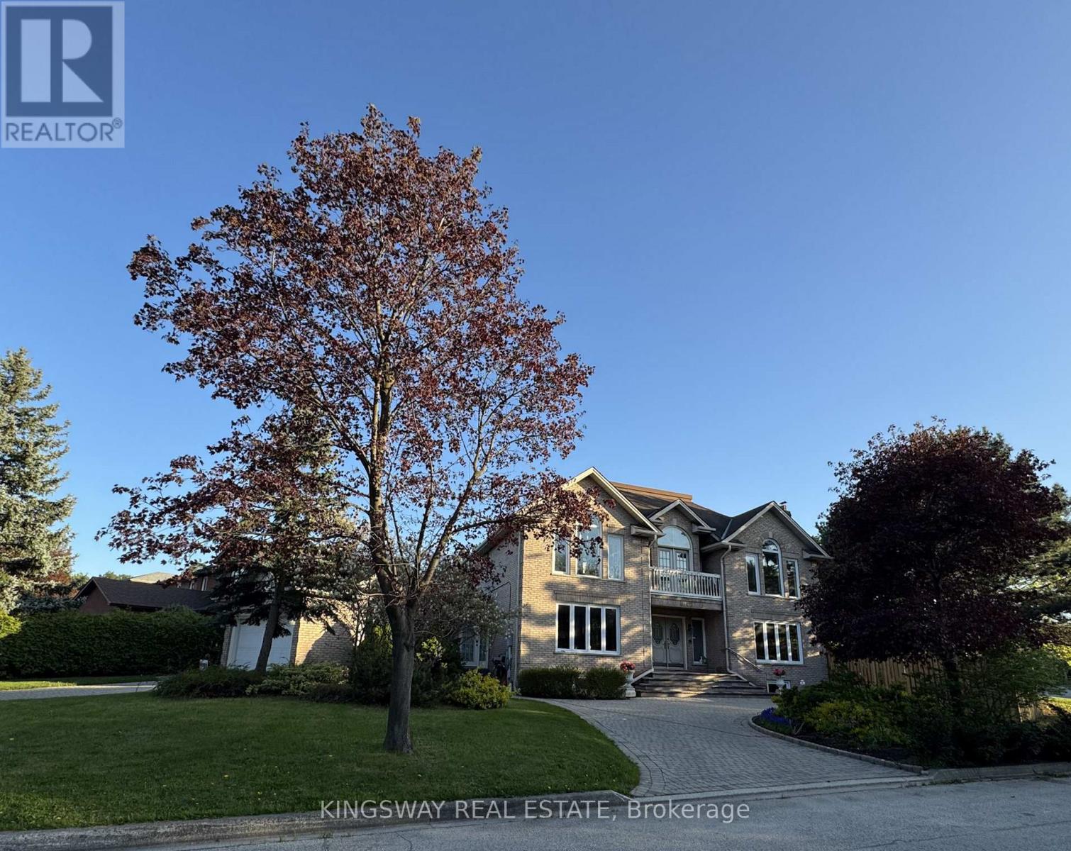 A large house with a tree in front of it.
