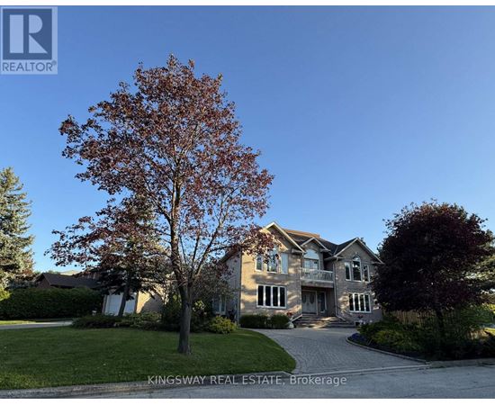 A large house with a tree in front of it.