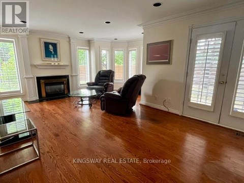 A living room with a fireplace and two chairs.