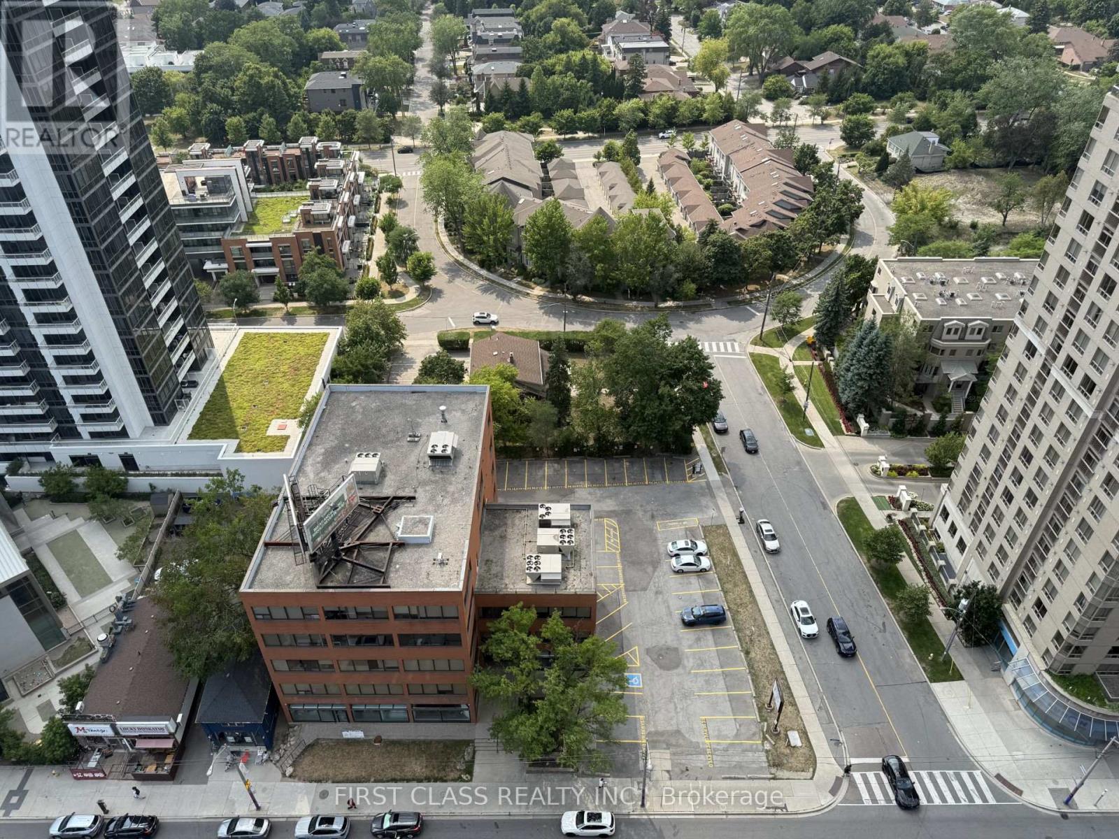 A view of a city street with cars and buildings.