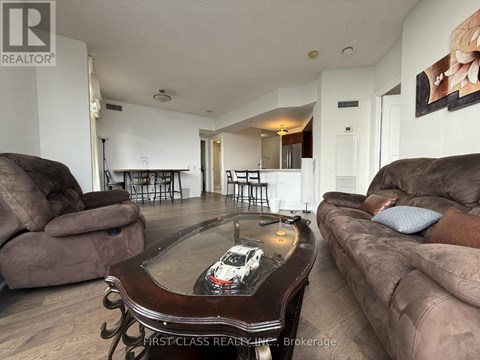 A living room with a coffee table in the middle and a couch on the right.