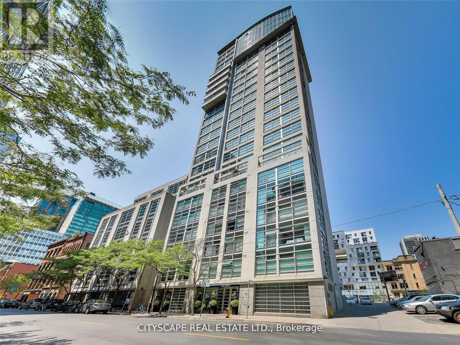 A tall building with many windows is the main focus of the image.