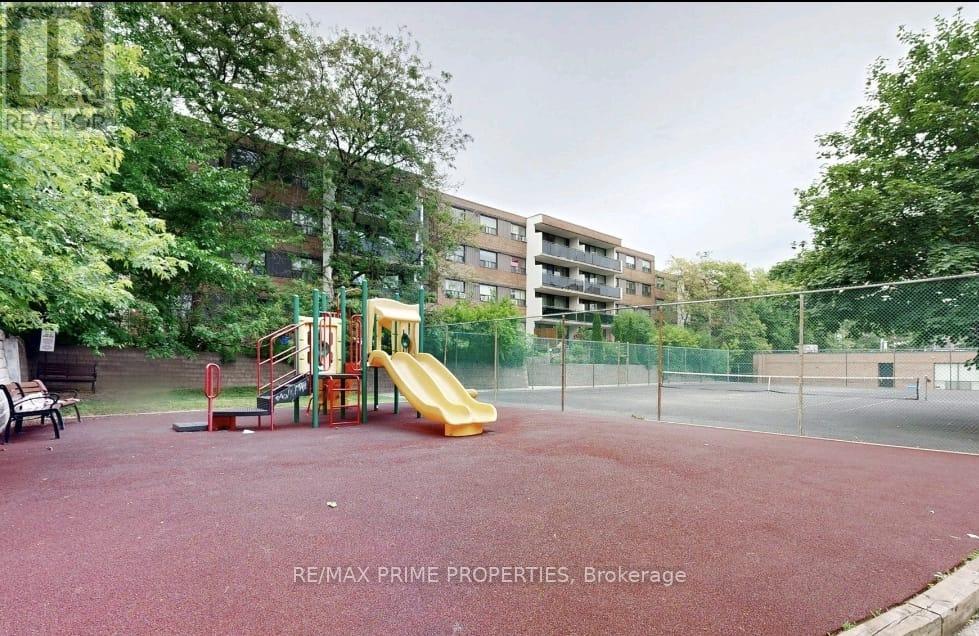A playground with a slide and a red surface.