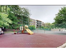 A playground with a slide and a red surface.